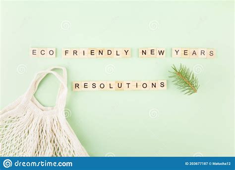 Phrase `eco Friendly New Year`s Resolutions` In Wooden Letters On Green