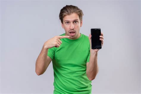 Free Photo Young Handsome Man Wearing Green T Shirt Holding