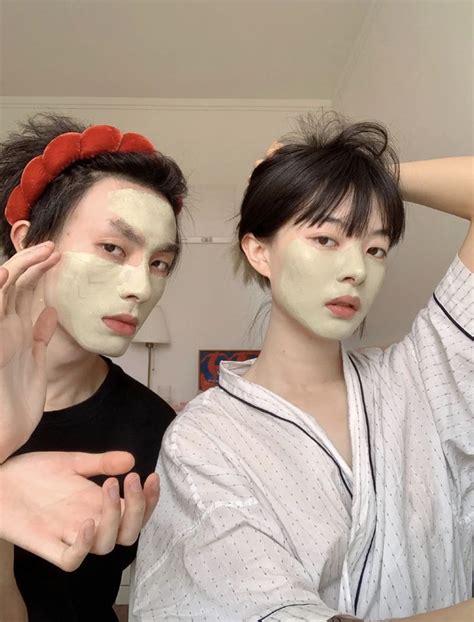 Two People With Facial Masks On Their Faces