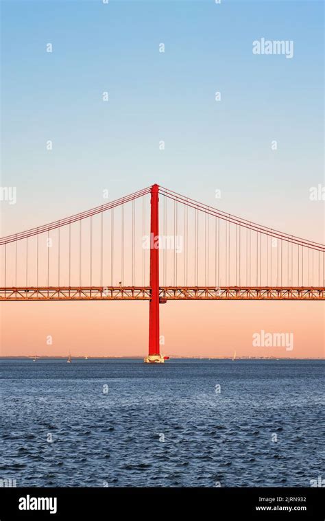 Iconic Orange Red Suspension Bridge Over Tagus River In Lisbon