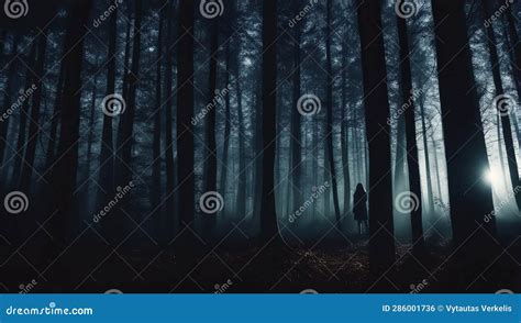 Silhouette Of A Man Walking In The Dark Forest With Fog Stock