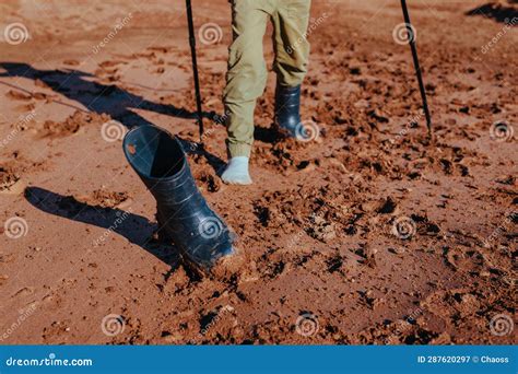 Boy Hiker With Trekking Poles Lost His Rubber Boot In Mud Focus On