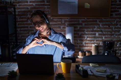 Beautiful Brunette Woman Working At The Office At Night Smiling In Love