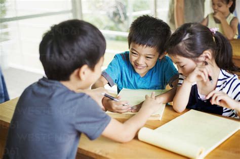 A Group Of Children In A Classroom Working Together Boys And Girls