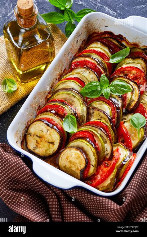 French Tian Provencal Baked Sliced Layered Vegetables In A Baking Dish On A Concrete Table With