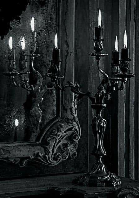 Black And White Photograph Of Candles In Front Of A Mirror With Wood