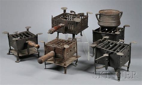 Five Wrought Iron Camp Stoves And A Footed Pot With Handles 18th And Early 19th Century Of