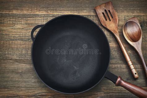 Empty Clean Cast Iron Frying Pan On Wooden Background Stock Image