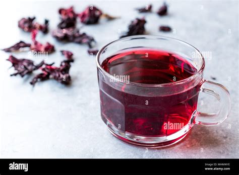 Red Hot Hibiscus Tea In A Glass Mug With Dry Hibiscus Tea Leaves