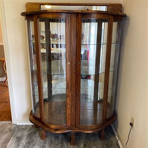 Oak And Curved Glass Claw Foot Lighted Curio Cabinet