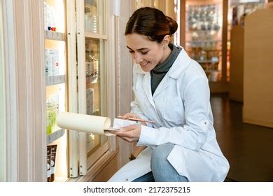 white apothecary wearing lab coat smiling stock photo