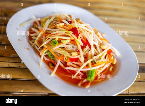 Som Tam Salad Dish With Green Papaya And Hot Chili Peppers Selective