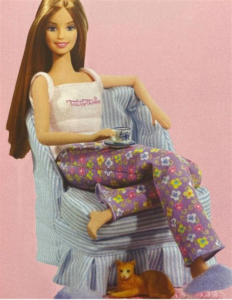 A Barbie Doll Sitting On Top Of A Chair