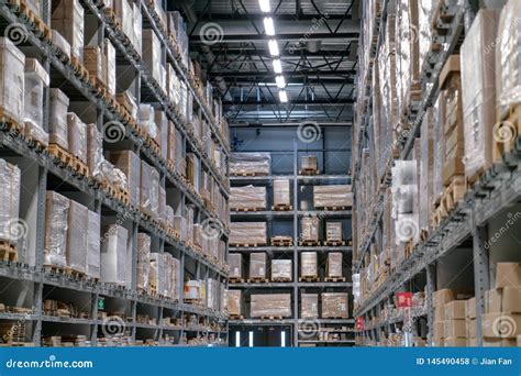 The Warehouse Full Of Goods Boxes And Shelves In Order Stock Photo