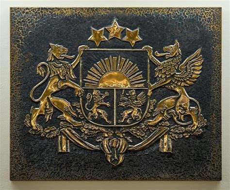 Premium Photo | Closeup of gold color coat of arms of latvia embossed ...