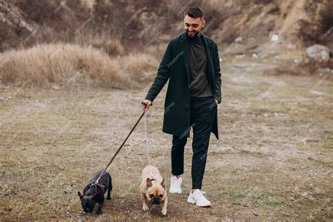 Free Photo Young Man Walking His French Bulldog In Park