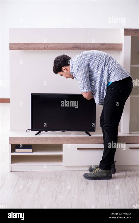 Man Trying To Fix Broken Tv Stock Photo Alamy