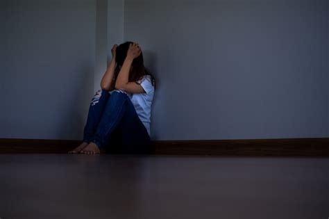 Premium Photo A Girl Sitting In A Dark Corner The Room Alone Is