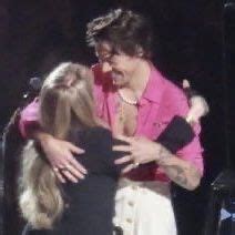 A Woman Is Hugging Another Woman On Stage