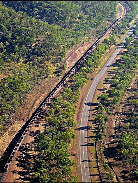 An Aerial View Of A Train Traveling Through The Country Side With Trees