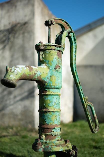 Premium Photo Old Hand Water Pump On A Well In The Garden Watering