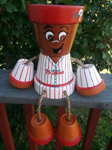 A Baseball Themed Planter Sitting On Top Of A Wooden Fence