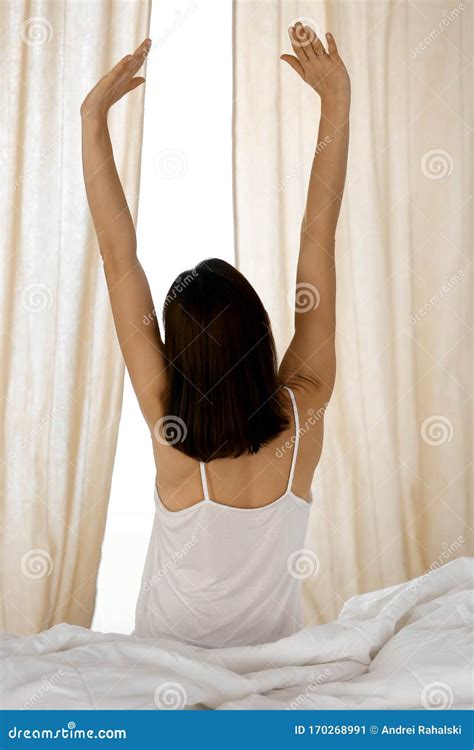 Woman Stretching Hands In Bed After Wake Up Sun Flare Brunette