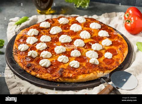 Hot Honey Pepperoni Pizza With Ricotta And Basil Stock Photo Alamy
