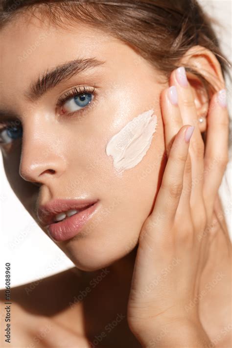 Face Skin Care Woman Applying Cosmetic Cream On Clean Hydrated Skin