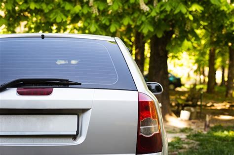 Premium Photo Back Window Of Grey Car Parked On The Street In Summer