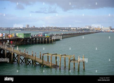 Southend Pier with Southend on Sea town beyond. Old sections of timber ...