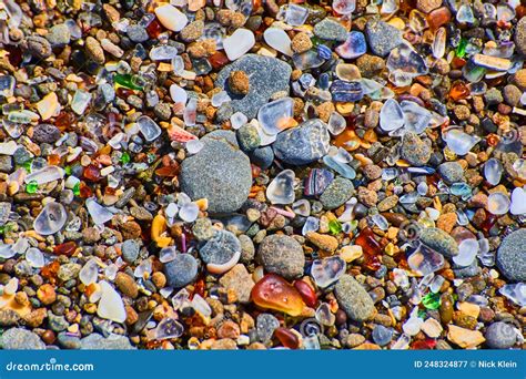 Beach Pebbles Of Smooth Colorful Rocks Covering Coast Stock Image