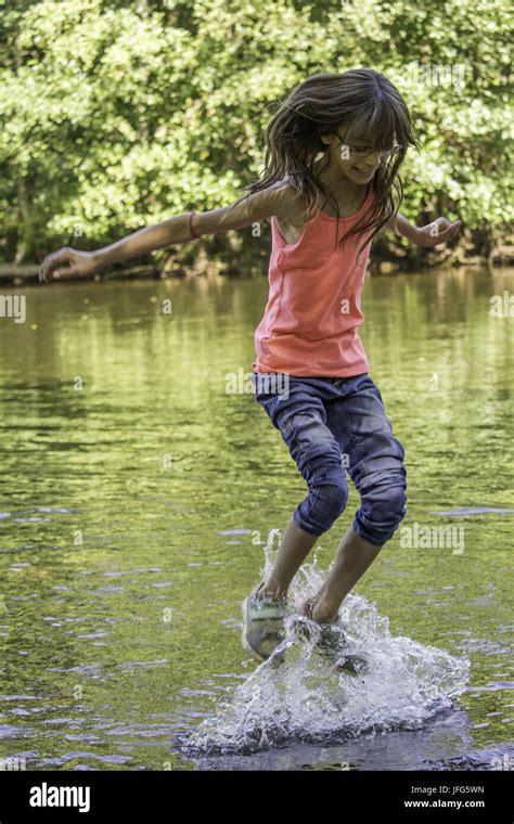 little Girl jumps in water Stock Photo - Alamy