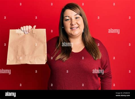 Beautiful Brunette Plus Size Woman Holding Take Away Paper Bag Looking
