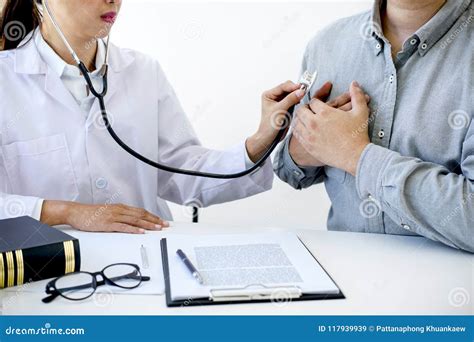 Female Doctor Checking Heart Beat Of Patient And Recommend Treat Stock