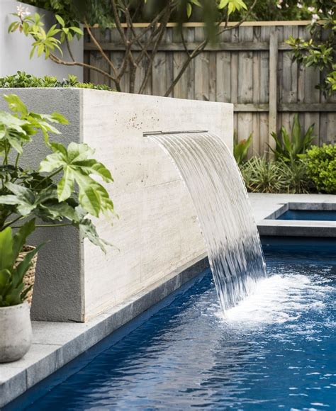 A Travertine Clad Water Feature Flows Into The Fibreglass Swimming Pool