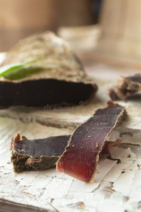 Sliced Venison Steak Dry Meat Of Wild Roe On Wooden Board Vertical