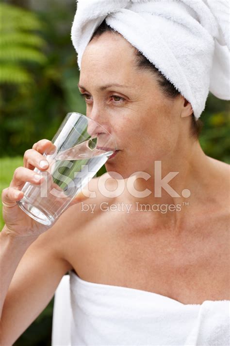 Mature Woman In Towel Drinking Water At Spa Stock Photo Royalty Free Images FreeImages