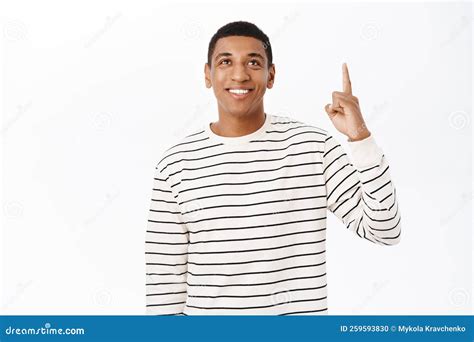 Happy African American Man Pointing Finger Up And Smiling Showing