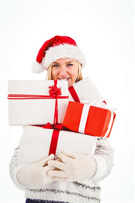유토이미지 Festive blonde holding pile of gifts
