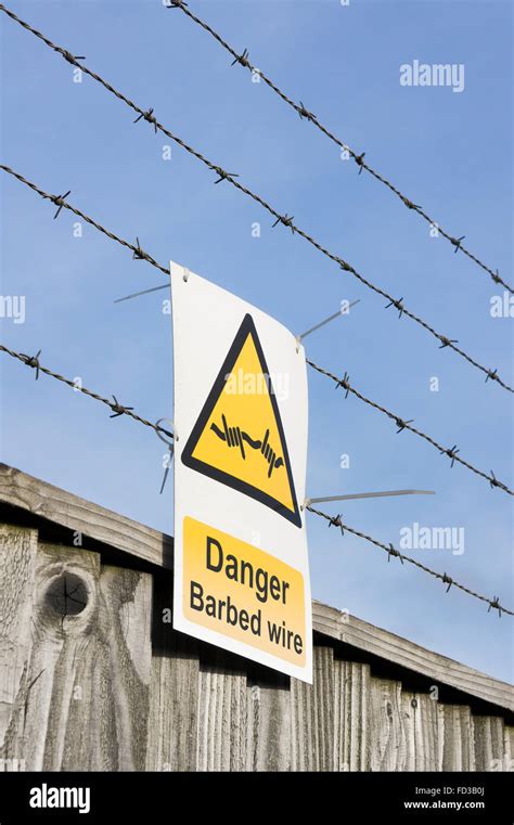 A Warning Sign On The Fence With Barbed Wire Stock Photo Alamy