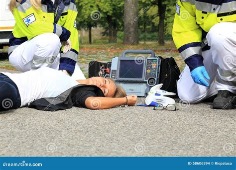 Woman After Accident With Paramedic And Defibrillator First Aid Stock