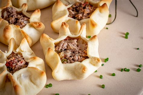 Arab Membuka Esfiha Daging Dengan Latar Belakang Pedesaan Foto Stok