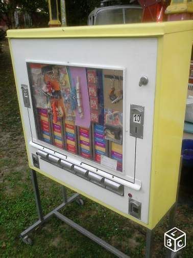 A Yellow And White Vending Machine Sitting In The Grass