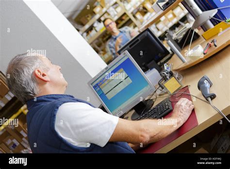 Mature Male Worker At Computer Workstation Stock Photo Alamy