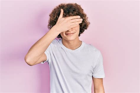 Handsome Young Man Wearing Casual White T Shirt Smiling And Laughing With Hand On Face Covering