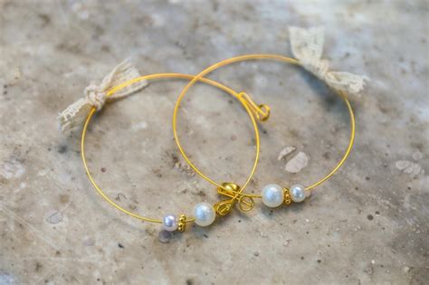 Premium Photo | Closeup of yellow pearl earrings on a rocky background