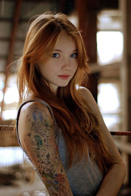 A Young Woman With Tattoos On Her Arm