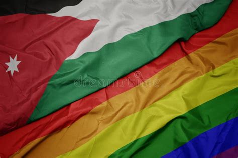 Waving Colorful Gay Rainbow Flag And National Flag Of Jordan Stock