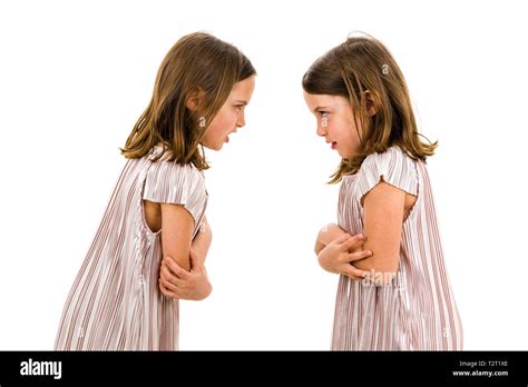 Identical Twin Girls Sisters Are Arguing Yelling At Each Other Angry